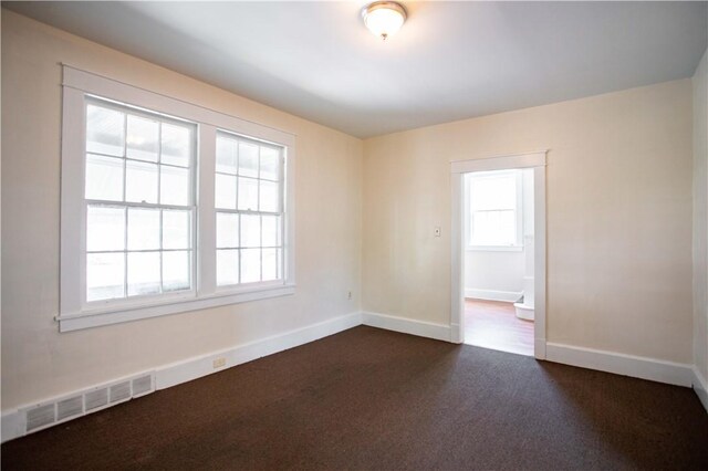 1315 Main St, Aliquippa, PA 15001 - unfurnished room featuring visible vents, baseboards, and dark carpet