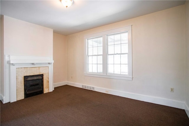 1315 Main St, Aliquippa, PA 15001 - unfurnished living room with baseboards, a fireplace, dark colored carpet, and visible vents