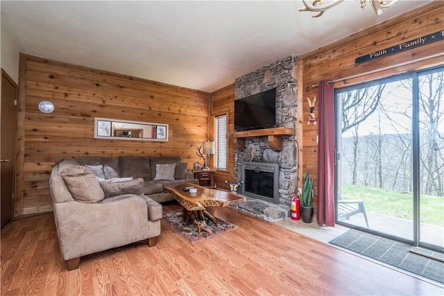 2805 Swiss Mountain Dr, Seven Springs Resort, PA 15622 - living area with a stone fireplace, wood finished floors, wooden walls, and a healthy amount of sunlight