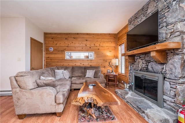2805 Swiss Mountain Dr, Seven Springs Resort, PA 15622 - living area featuring a baseboard radiator, wood walls, a stone fireplace, and wood finished floors