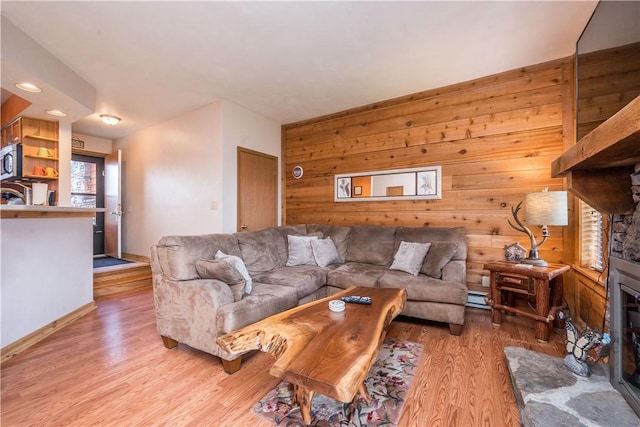 2805 Swiss Mountain Dr, Seven Springs Resort, PA 15622 - living area with wooden walls, a fireplace, light wood-style flooring, recessed lighting, and a baseboard heating unit