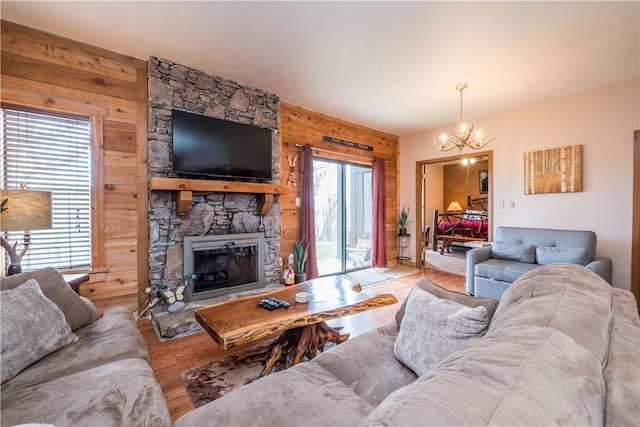 2805 Swiss Mountain Dr, Seven Springs Resort, PA 15622 - living room featuring an inviting chandelier, wood walls, wood finished floors, and a stone fireplace