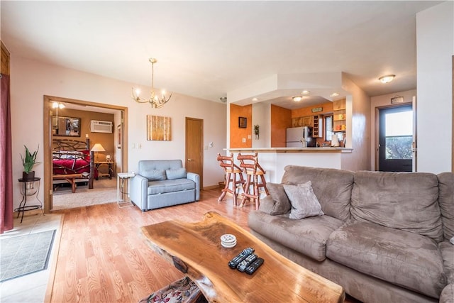 2805 Swiss Mountain Dr, Seven Springs Resort, PA 15622 - living room with light wood-type flooring, a notable chandelier, and an AC wall unit