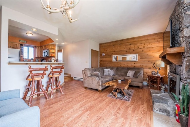 2805 Swiss Mountain Dr, Seven Springs Resort, PA 15622 - living area with wooden walls, light wood-type flooring, recessed lighting, a baseboard heating unit, and a chandelier
