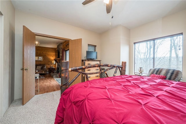 2805 Swiss Mountain Dr, Seven Springs Resort, PA 15622 - bedroom with wooden walls, a ceiling fan, multiple windows, and carpet