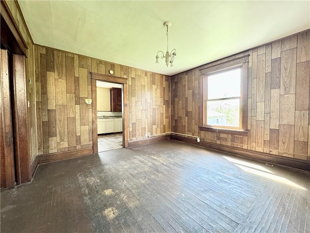 432 Boyles Ave, New Castle/2Nd, PA 16101 - unfurnished room with wooden walls, baseboards, a notable chandelier, and wood-type flooring