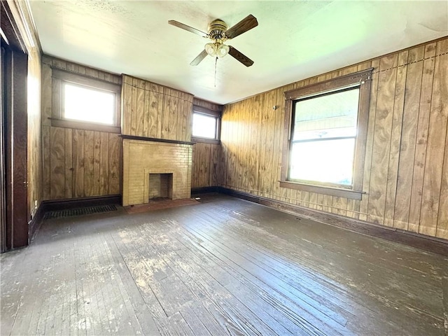432 Boyles Ave, New Castle/2Nd, PA 16101 - unfurnished living room featuring wood-type flooring, ceiling fan, wood walls, and a fireplace
