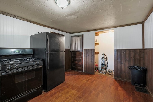 114 Angel Ave, Fairview Twp But, PA 16050 - kitchen featuring black appliances, wood finished floors, wood walls, and a wainscoted wall