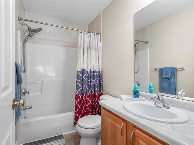 bathroom with vanity, tile patterned floors, shower / bath combo with shower curtain, and toilet