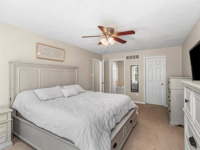 bedroom featuring a ceiling fan, visible vents, baseboards, connected bathroom, and light carpet