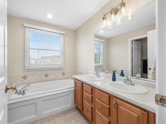 full bath featuring a sink, tile patterned flooring, a garden tub, and double vanity