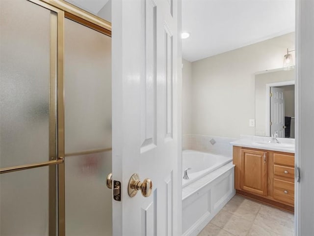 bathroom featuring an enclosed shower, a garden tub, and vanity