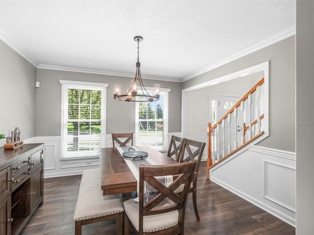 dining space featuring a wainscoted wall, ornamental molding, dark wood-type flooring, and a chandelier