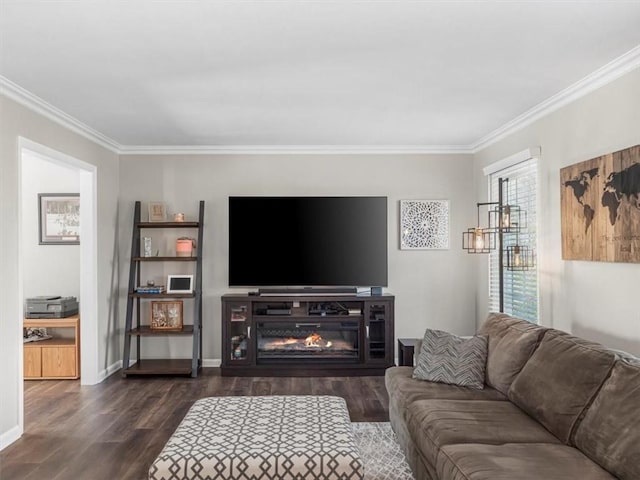 living room with baseboards, dark wood-style floors, ornamental molding, and a glass covered fireplace