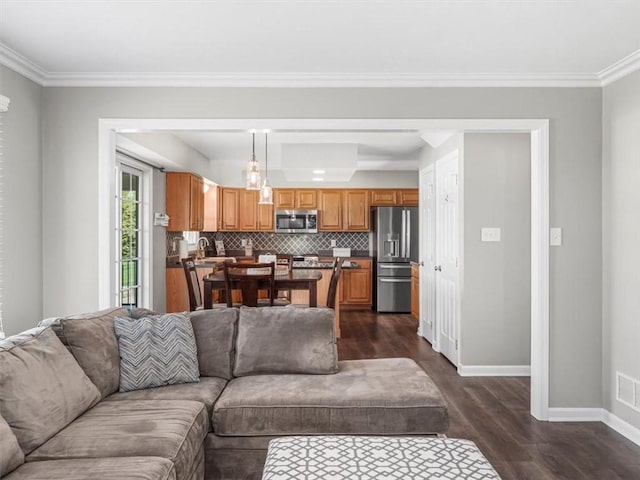 living room with crown molding, baseboards, and dark wood-style floors