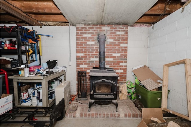 below grade area with a wood stove and concrete block wall