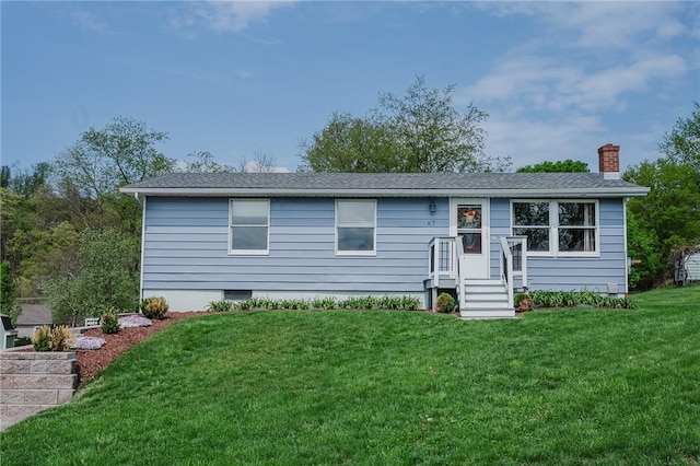 view of front of home with a chimney and a front lawn