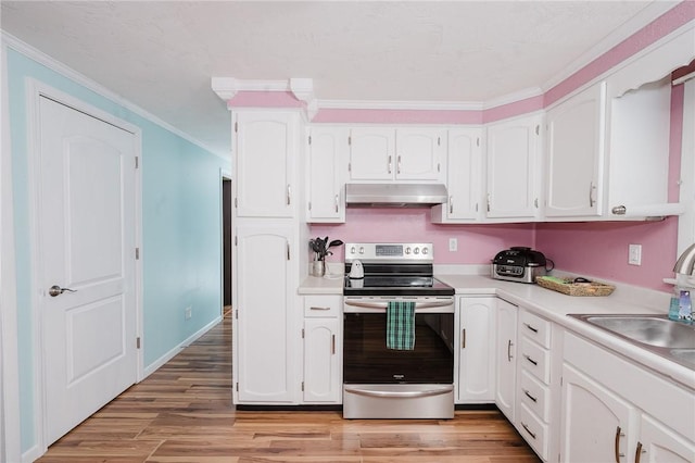 kitchen with light countertops, stainless steel electric range oven, ornamental molding, and under cabinet range hood