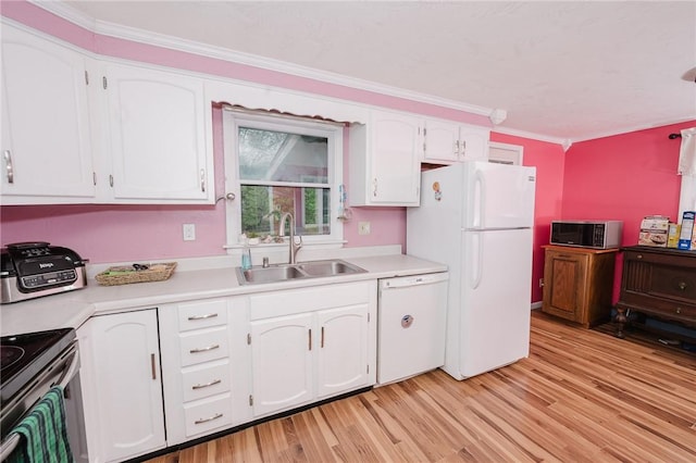 kitchen featuring white appliances, white cabinets, a sink, and light countertops