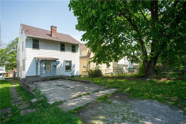 1211 Main St, Aliquippa, PA 15001 - rear view of property featuring a patio, fence, and a chimney
