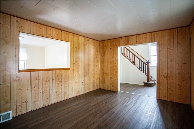 1211 Main St, Aliquippa, PA 15001 - empty room with stairway, dark wood-style flooring, wooden walls, and visible vents