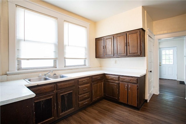 1211 Main St, Aliquippa, PA 15001 - kitchen with dark brown cabinetry, tasteful backsplash, a sink, light countertops, and dark wood-type flooring
