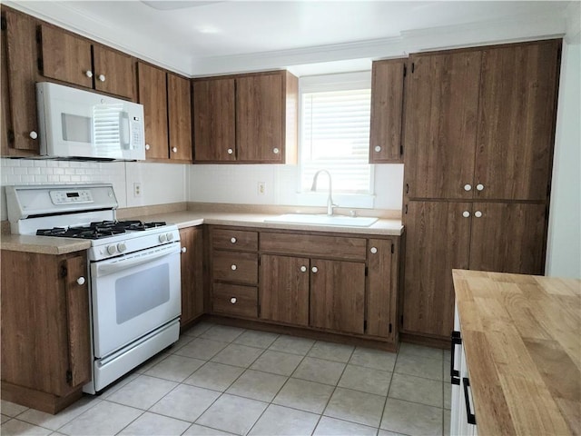 525 E Old Lincoln Hwy, Ligonier Twp, PA 15658 - kitchen featuring white appliances, light tile patterned floors, a sink, and tasteful backsplash