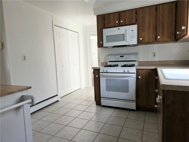 525 E Old Lincoln Hwy, Ligonier Twp, PA 15658 - kitchen with dark brown cabinetry, baseboard heating, light tile patterned floors, a sink, and white appliances