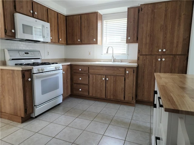 525 E Old Lincoln Hwy, Ligonier Twp, PA 15658 - kitchen with butcher block countertops, a sink, white appliances, and tasteful backsplash