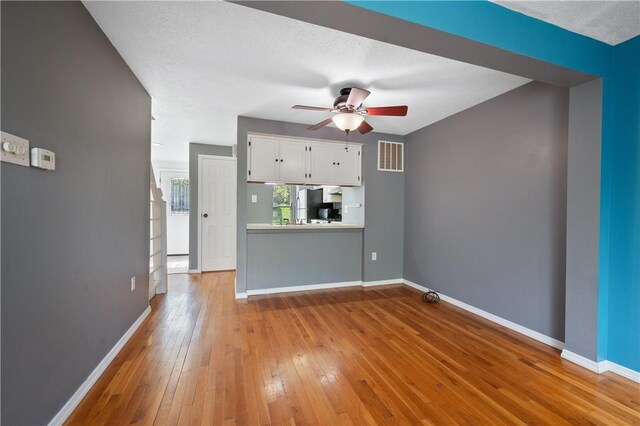 6326 Springhouse Pl, South Fayette, PA 15017 - unfurnished living room with baseboards, ceiling fan, visible vents, and hardwood / wood-style flooring