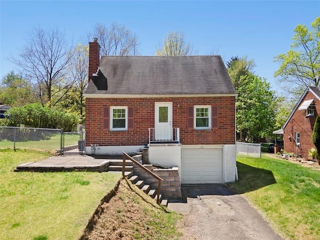 view of front of property featuring driveway, a chimney, fence, a front lawn, and an attached garage