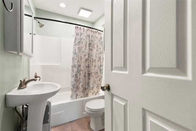 full bath featuring tile patterned floors, toilet, and shower / bath combination with curtain
