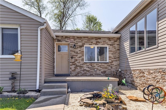 entrance to property featuring stone siding
