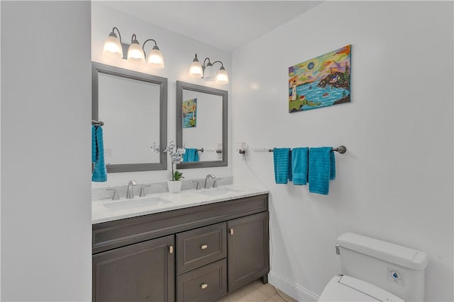 full bathroom with a sink, tile patterned floors, toilet, and double vanity