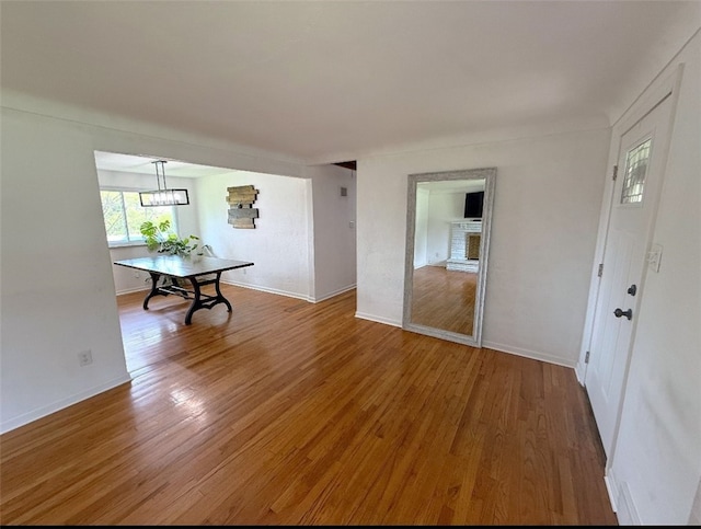 4402 Gateway Dr, Monroeville, PA 15146 - dining room featuring a fireplace, baseboards, and light wood-style floors