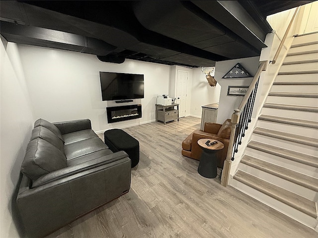 4402 Gateway Dr, Monroeville, PA 15146 - living area featuring a glass covered fireplace, stairs, and wood finished floors
