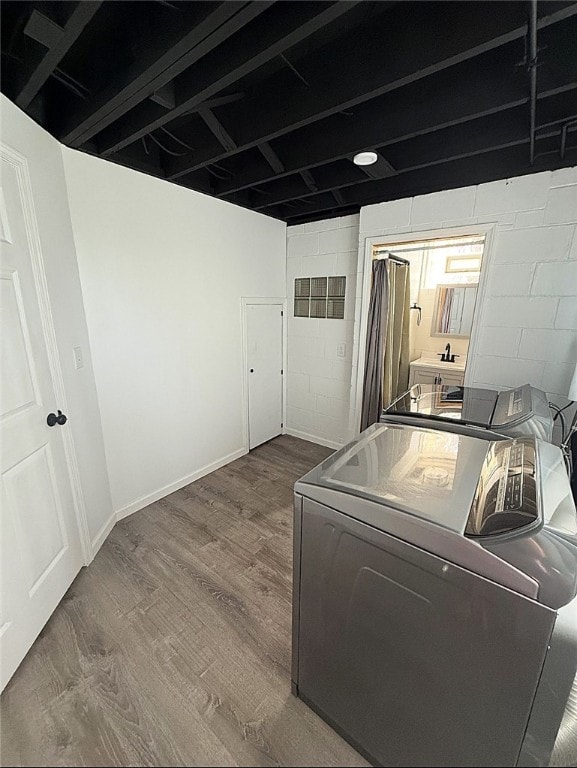 4402 Gateway Dr, Monroeville, PA 15146 - laundry area with laundry area, washer / dryer, wood finished floors, and concrete block wall