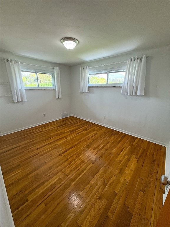 4402 Gateway Dr, Monroeville, PA 15146 - unfurnished room with a healthy amount of sunlight, baseboards, wood-type flooring, and visible vents