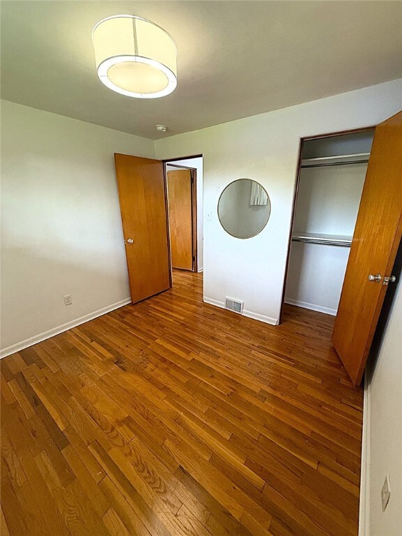 4402 Gateway Dr, Monroeville, PA 15146 - unfurnished bedroom with visible vents, wood-type flooring, baseboards, and a closet
