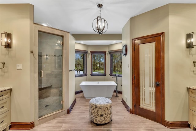 118 Lakeland Dr, Adams Twp, PA 16046 - full bath with baseboards, a shower stall, a freestanding tub, and vanity