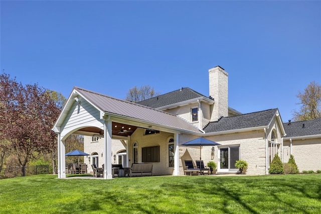 118 Lakeland Dr, Adams Twp, PA 16046 - back of property featuring a lawn, ceiling fan, a chimney, and a patio area