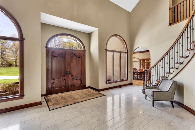 118 Lakeland Dr, Adams Twp, PA 16046 - entrance foyer featuring baseboards, a wealth of natural light, high vaulted ceiling, and stairway