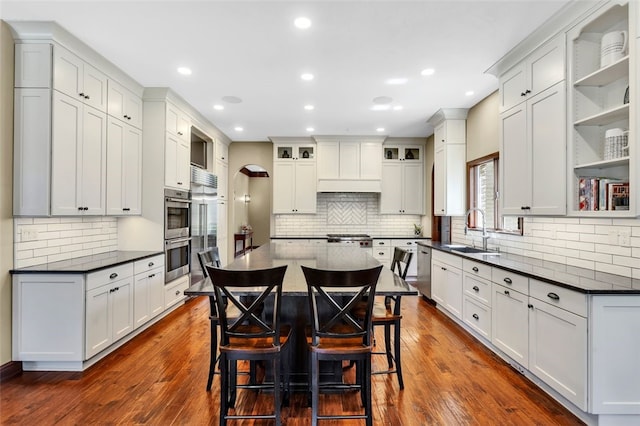 118 Lakeland Dr, Adams Twp, PA 16046 - kitchen with a sink, decorative backsplash, stainless steel appliances, and a kitchen bar