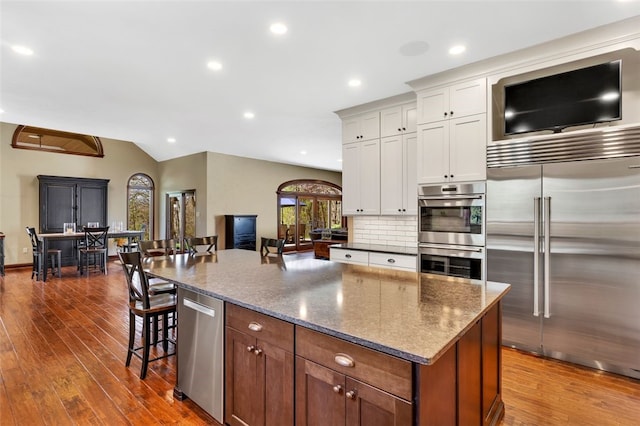 118 Lakeland Dr, Adams Twp, PA 16046 - kitchen featuring white cabinets, stainless steel appliances, dark wood finished floors, and a breakfast bar area