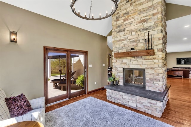 118 Lakeland Dr, Adams Twp, PA 16046 - living room featuring a fireplace, high vaulted ceiling, a chandelier, baseboards, and wood finished floors