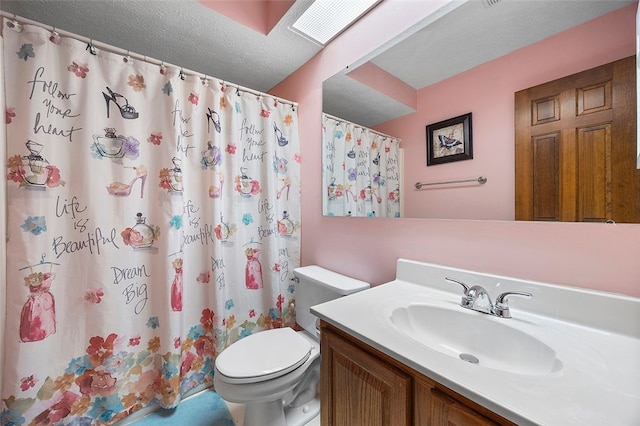 bathroom with vanity, a textured ceiling, toilet, and curtained shower