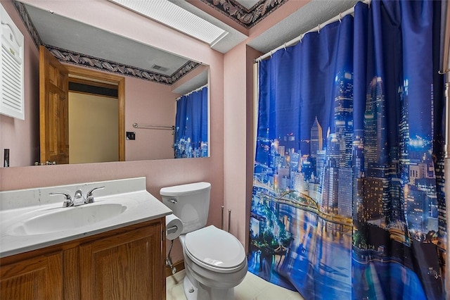 bathroom featuring vanity, curtained shower, and toilet