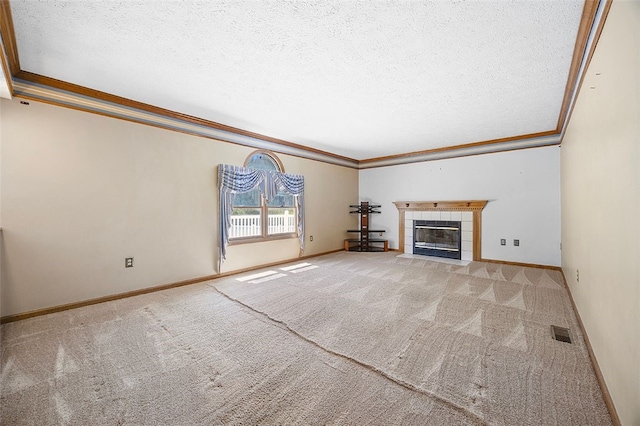 unfurnished living room featuring visible vents, a textured ceiling, crown molding, and carpet floors