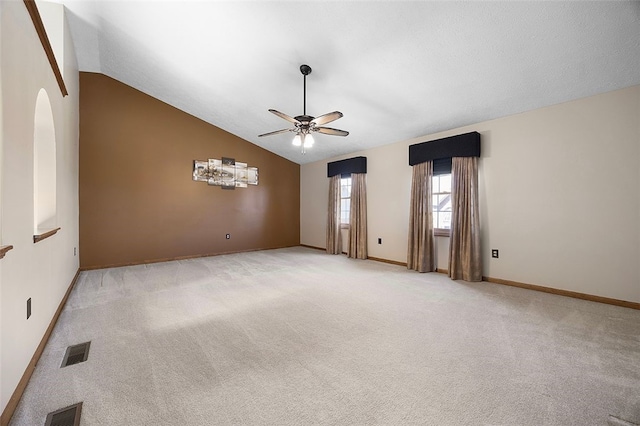 unfurnished room with light colored carpet, a ceiling fan, lofted ceiling, and visible vents