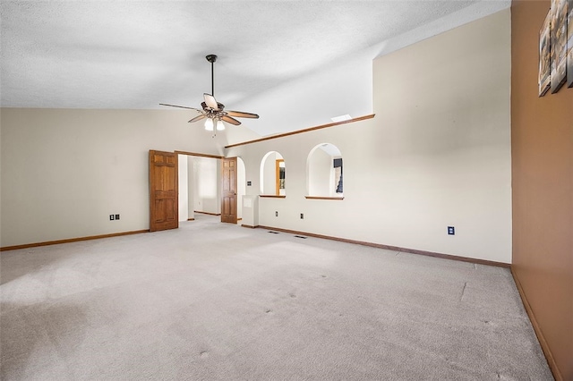 unfurnished room featuring baseboards, ceiling fan, light carpet, and high vaulted ceiling